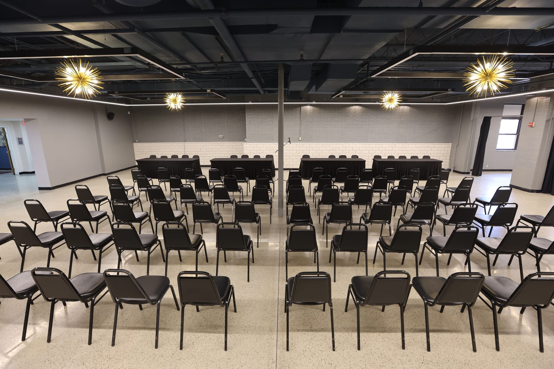 Rows of chairs facing the draped head tables at the Event Center